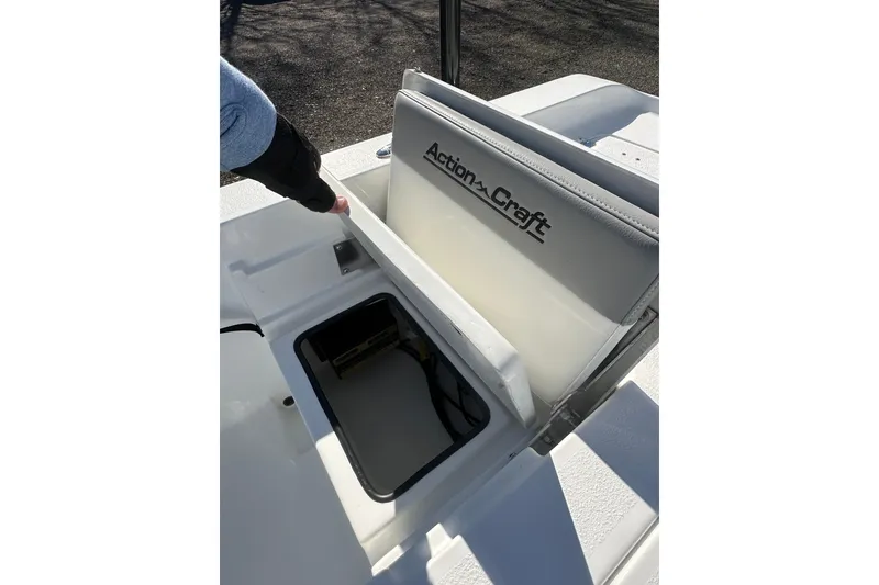 Slide: The Image of 2026 Action Craft 24 Bay boat seat storage compartment open, showcasing interior space. - 32
