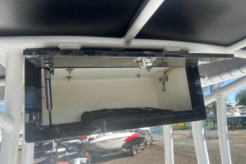 Slide: The Image of 2026 Action Craft 24 Bay boat storage compartment with open hatch and hydraulic support. - 35