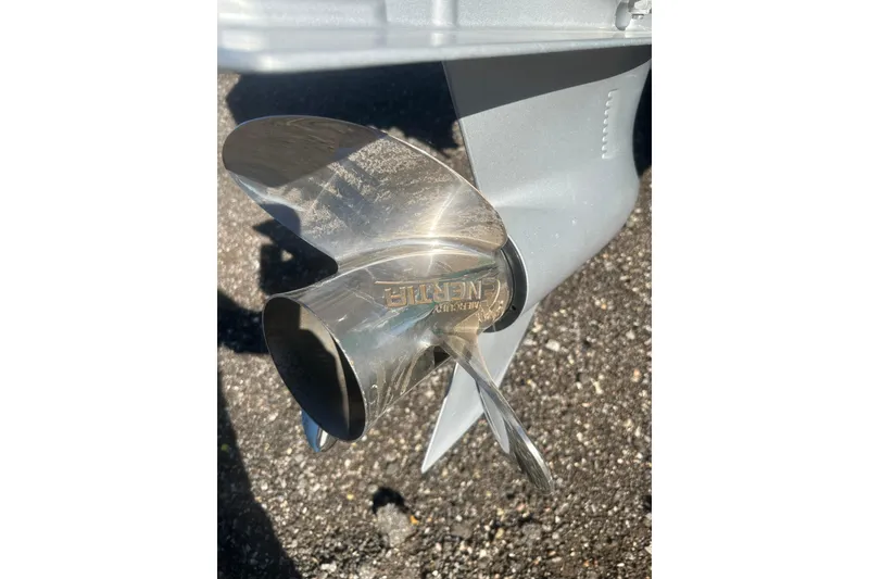 Slide: The Image of Close-up of a shiny boat propeller on a 2026 Action Craft 24 Bay. - 8