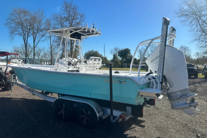 Slide: The Image of 2026 Action Craft 24 Bay boat on trailer, parked outdoors under clear blue sky. - 9