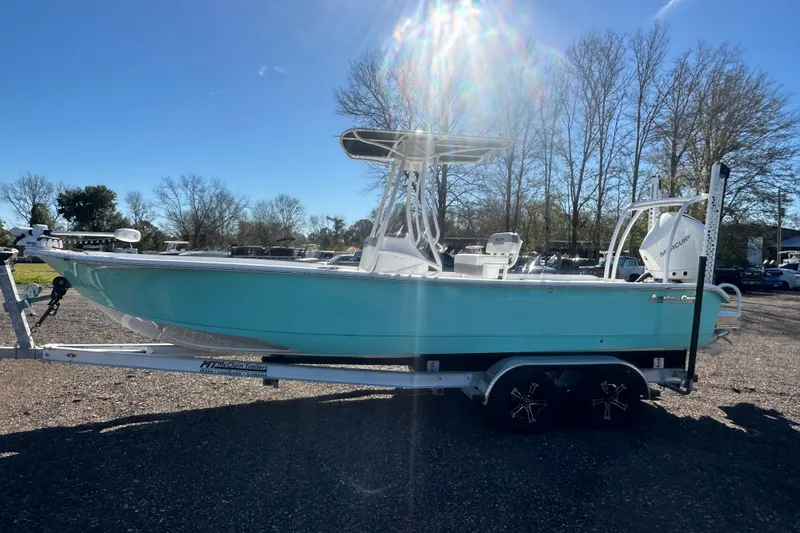 Slide: The Image of 2026 Action Craft 24 Bay boat on trailer under sunny sky. - 10