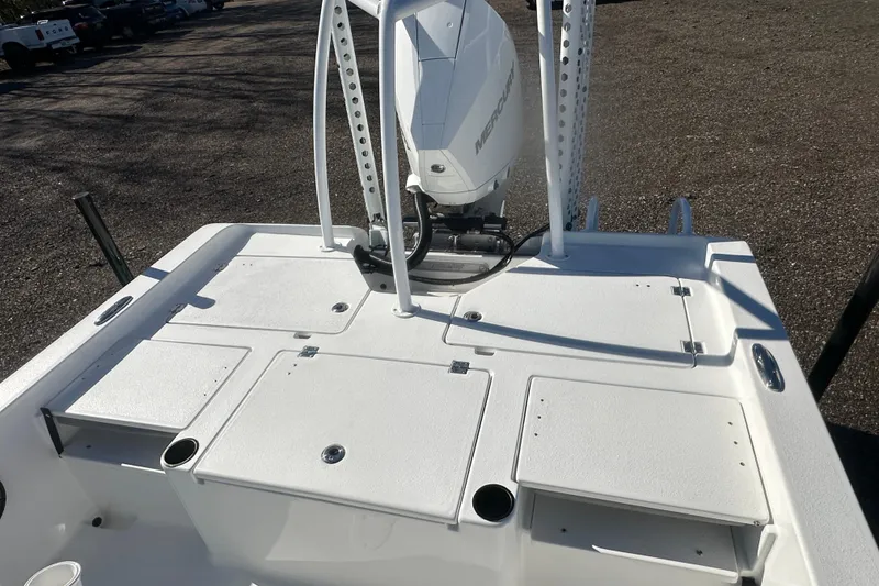 Slide: The Image of 2026 Action Craft 24 Bay boat deck with Mercury engine, featuring storage compartments. - 13