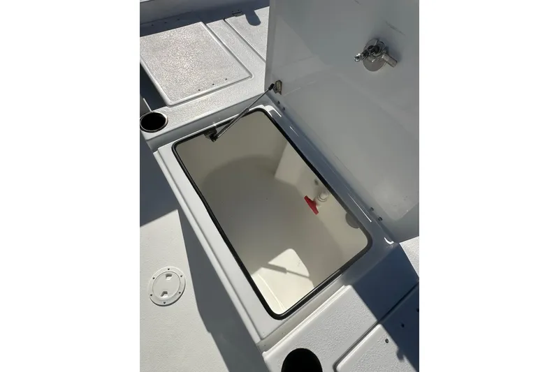 Slide: The Image of Open storage compartment on 2026 Action Craft 24 Bay boat deck. - 16