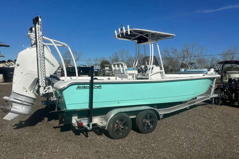 Slide: The Image of 2026 Action Craft 24 Bay boat on trailer, featuring a sleek design and Mercury outboard motor. - 3