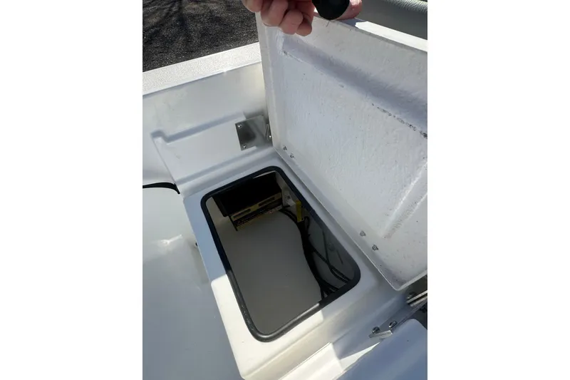 Slide: The Image of Open storage compartment on 2026 Action Craft 24 Bay boat, showing interior details. - 31