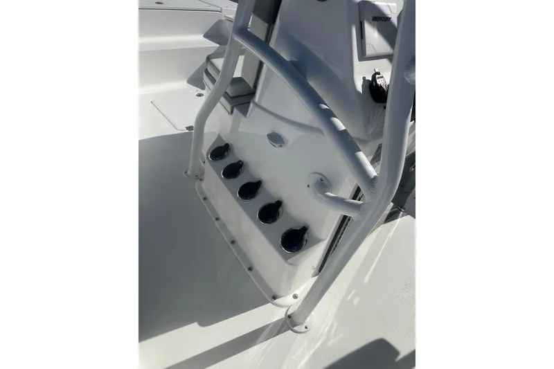 Slide: The Image of 2026 Action Craft 24 Bay boat console with rod holders and Mercury controls. - 37