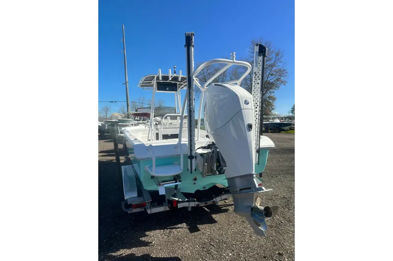 Slide: The Image of 2026 Action Craft 24 Bay boat with outboard motor, parked on a trailer. - 5