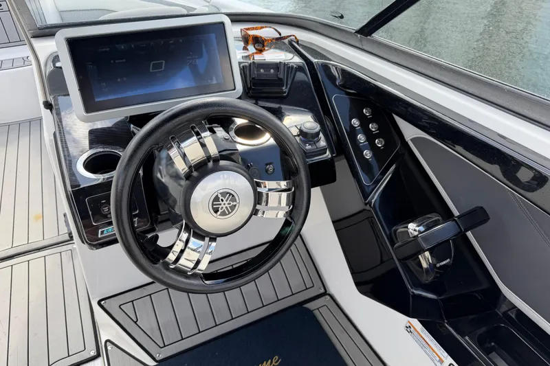 Slide: The Image of 2022 Yamaha Boats 252SD dashboard with steering wheel and touchscreen display. - 13