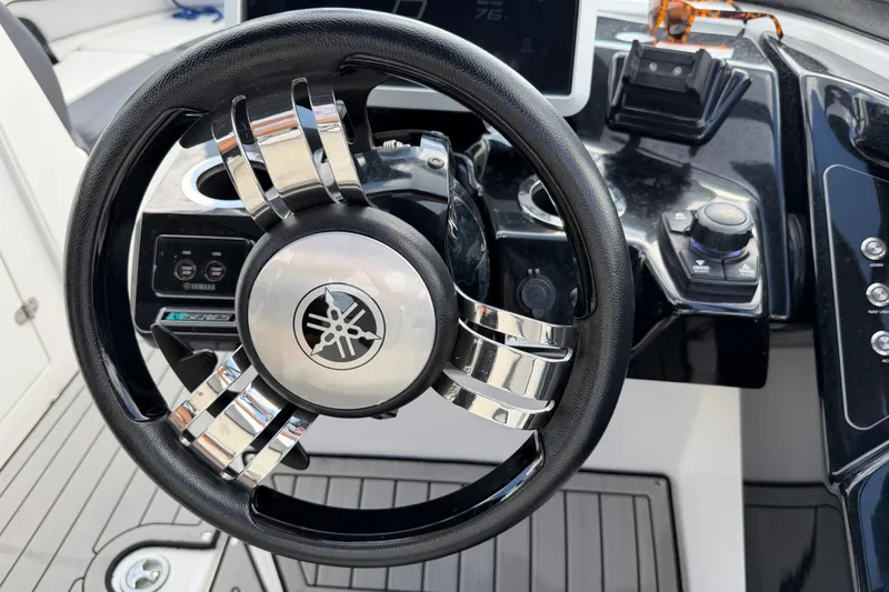 Slide: The Image of 2022 Yamaha Boats 252SD steering wheel and dashboard controls. - 14