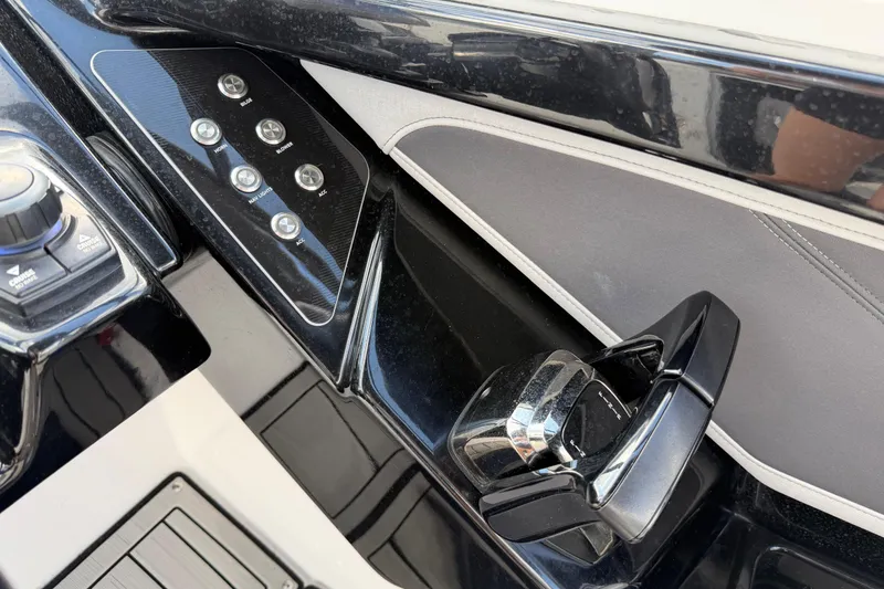 Slide: The Image of 2022 Yamaha Boats 252SD control panel with sleek black and chrome design. - 16