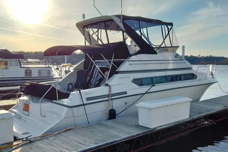 The Image of 1994 Carver 380 Santego yacht docked at marina during sunset. - 0