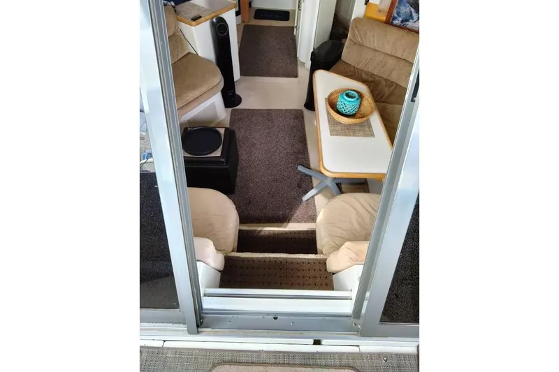 Slide: The Image of Interior of 1994 Carver 380 Santego yacht with cozy seating and table setup. - 11