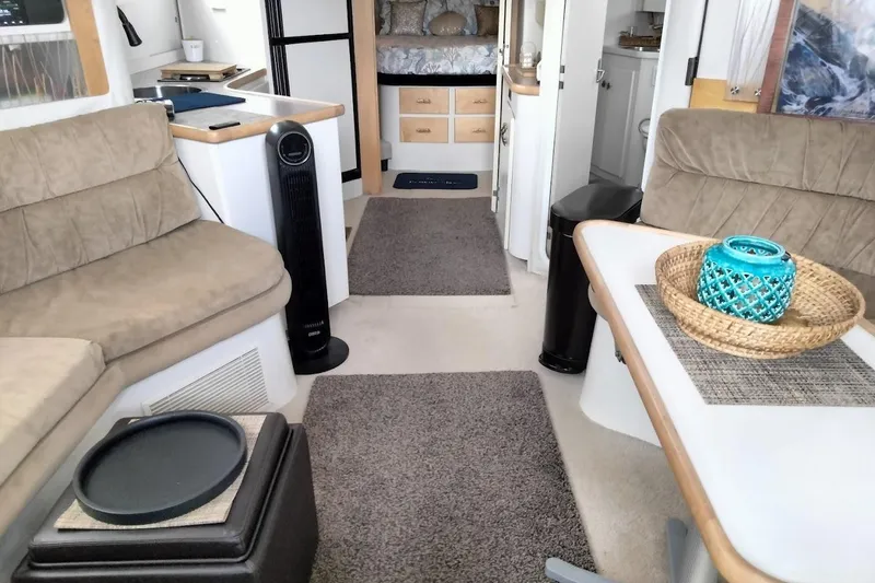Slide: The Image of Interior of a 1994 Carver 380 Santego yacht with cozy seating and modern decor. - 12