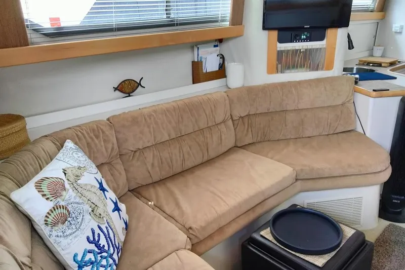Slide: The Image of Cozy interior of 1994 Carver 380 Santego yacht with beige sofa and nautical decor. - 14