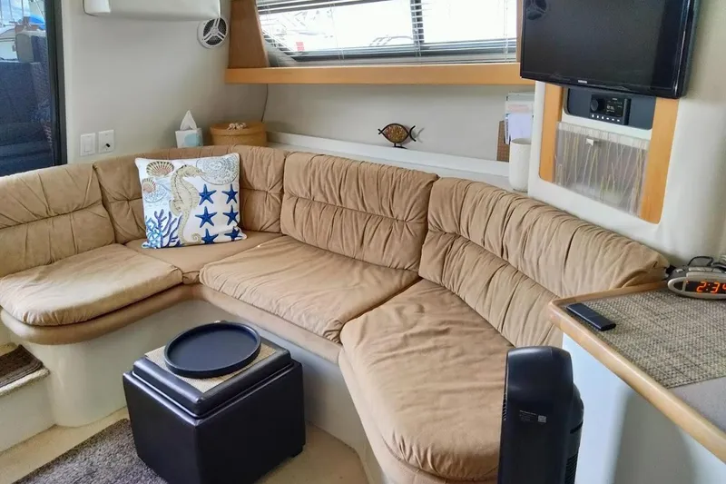 Slide: The Image of Cozy interior of 1994 Carver 380 Santego with beige seating and nautical decor. - 15