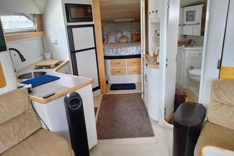 Slide: The Image of 1994 Carver 380 Santego yacht interior with kitchen, bed, and bathroom. - 18