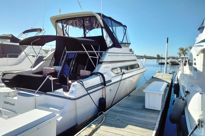 Slide: The Image of 1994 Carver 380 Santego yacht docked at marina under clear blue sky. - 2