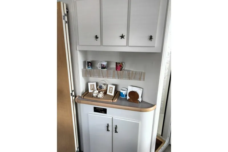 Slide: The Image of 1994 Carver 380 Santego interior with cabinets and decorative items. - 20