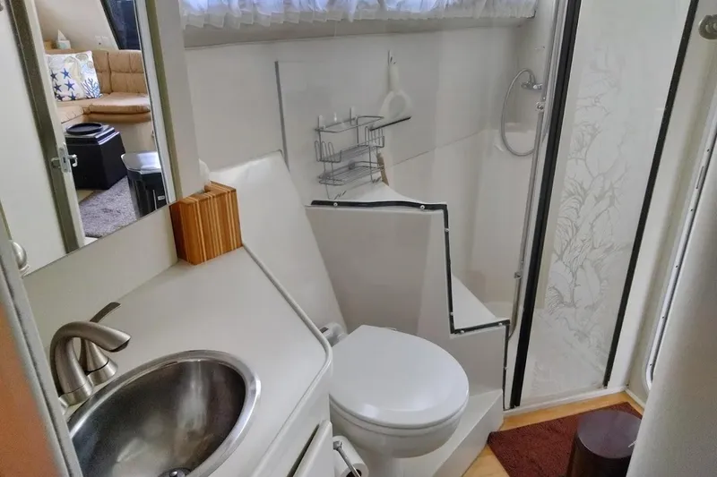 Slide: The Image of Bathroom interior of a 1994 Carver 380 Santego yacht, featuring a sink and toilet. - 21