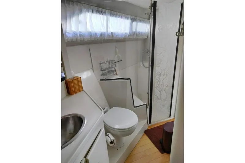 Slide: The Image of Bathroom interior of 1994 Carver 380 Santego yacht, featuring shower and toilet. - 22