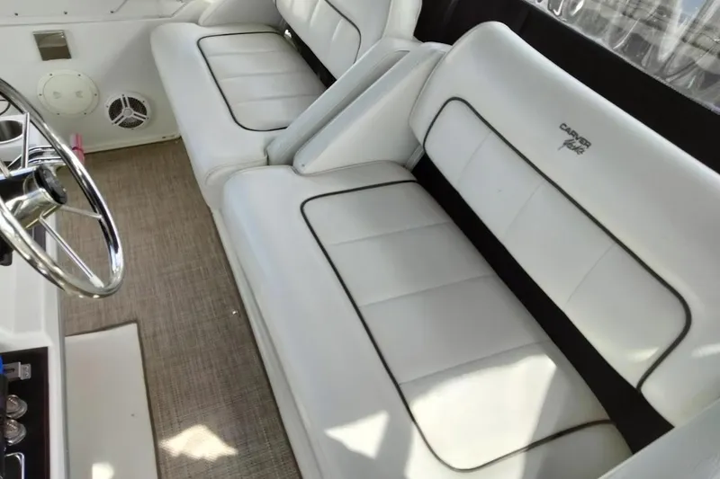 Slide: The Image of 1994 Carver 380 Santego interior with white seating and steering wheel. - 28