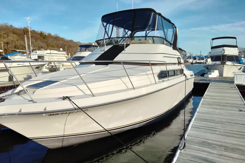 Slide: The Image of 1994 Carver 380 Santego yacht docked at marina under clear blue sky. - 3