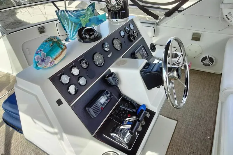 Slide: The Image of 1994 Carver 380 Santego helm with gauges, steering wheel, and nautical decor. - 32