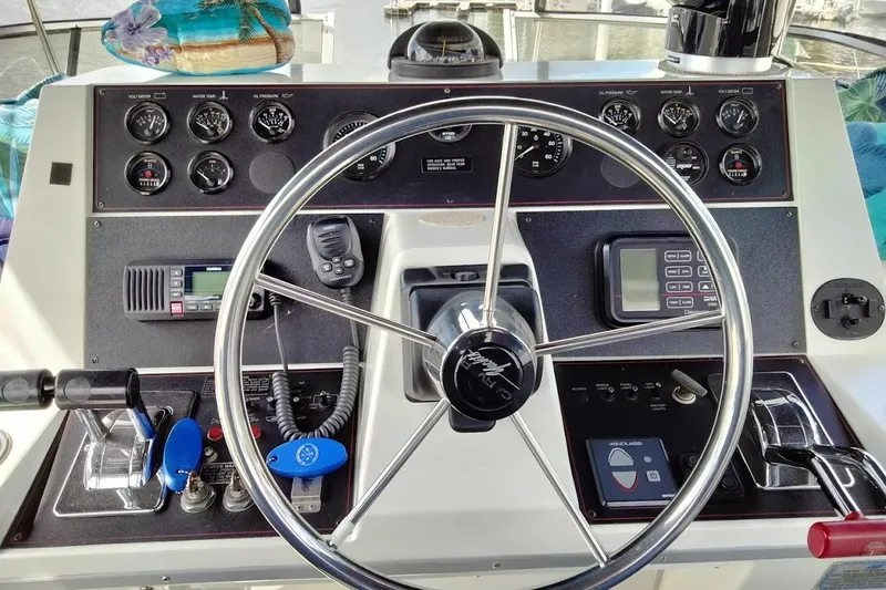 Slide: The Image of 1994 Carver 380 Santego helm with steering wheel, gauges, and navigation controls. - 33