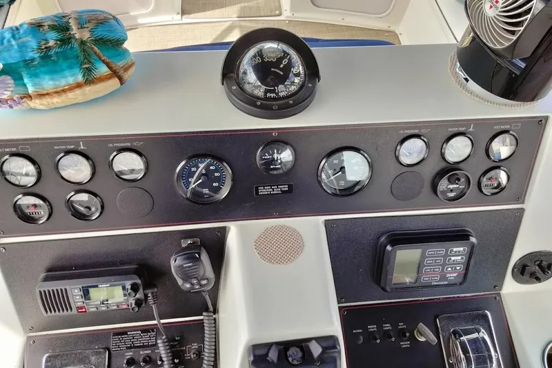 Slide: The Image of 1994 Carver 380 Santego dashboard with gauges, compass, and communication equipment. - 34