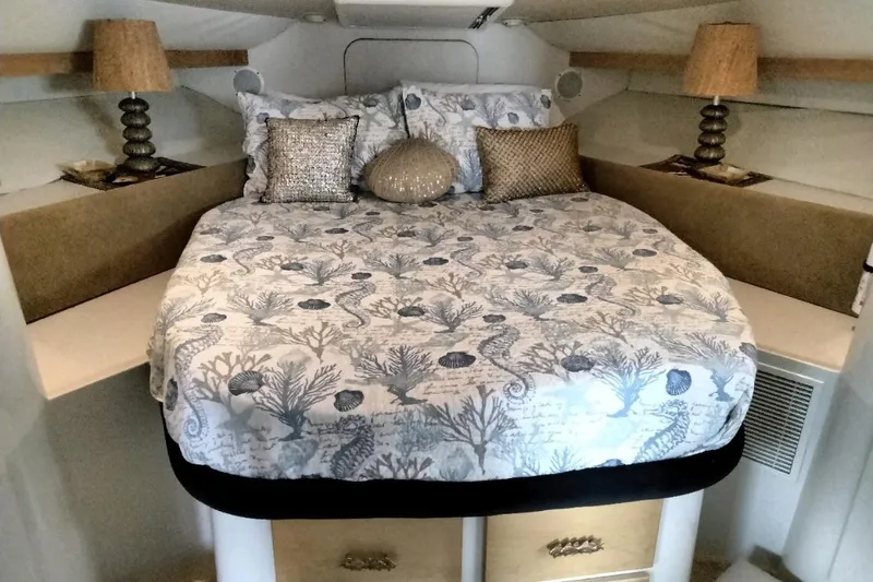 Slide: The Image of Cozy bedroom in 1994 Carver 380 Santego yacht with nautical-themed bedding and elegant lamps. - 8