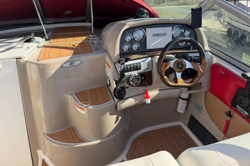 Slide: The Image of 2006 Four Winns 278 Vista boat cockpit with steering wheel and control panel. - 12