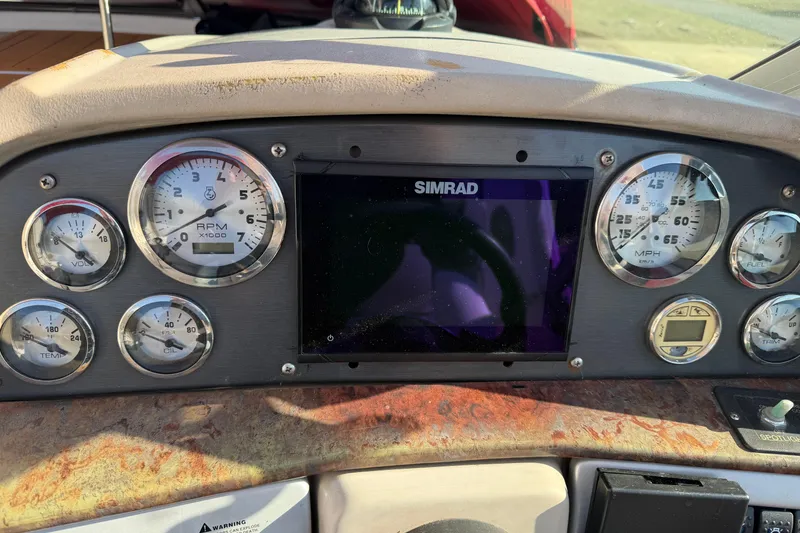 Slide: The Image of Dashboard of a 2006 Four Winns 278 Vista boat with gauges and Simrad display. - 13