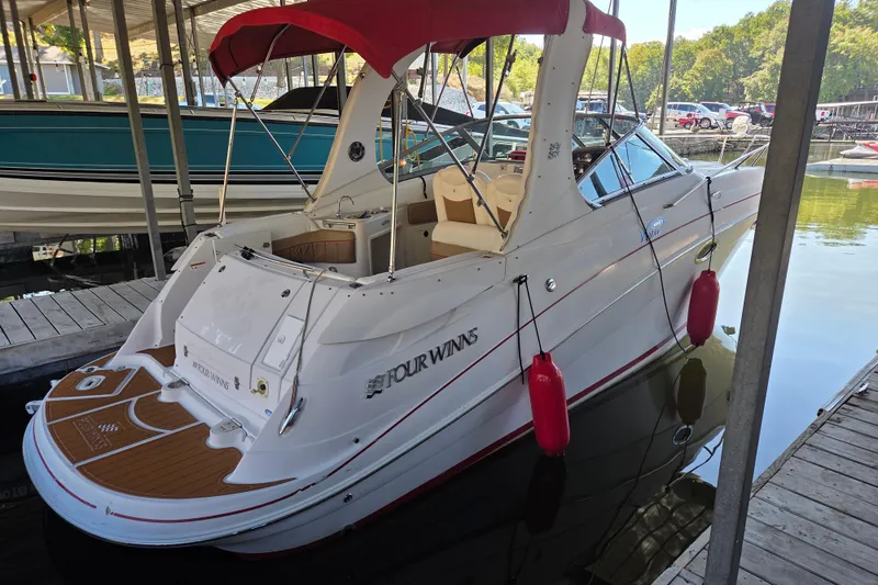 Slide: The Image of 2006 Four Winns 278 Vista boat docked with red canopy and fenders. - 2