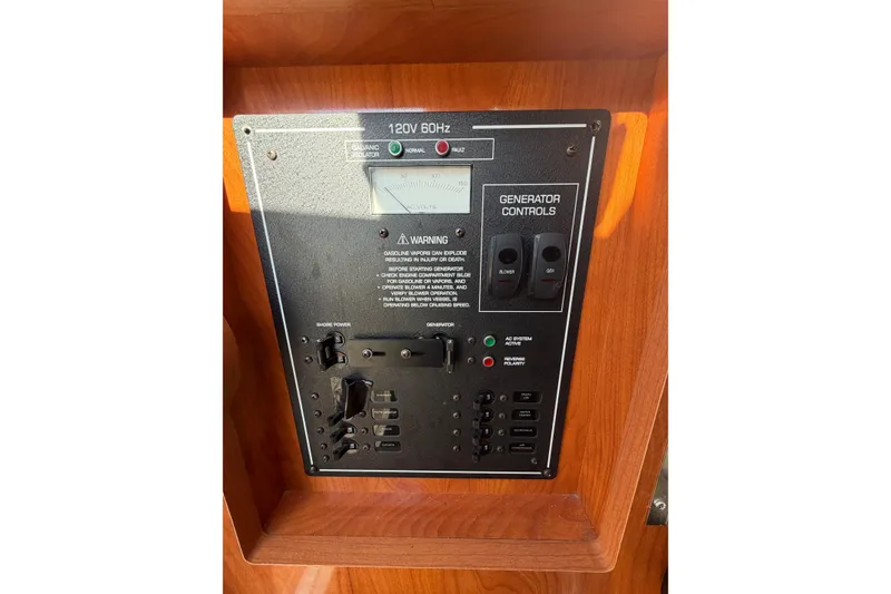 Slide: The Image of Control panel of a 2006 Four Winns 278 Vista boat, featuring generator controls. - 24