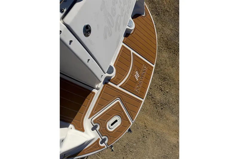 Slide: The Image of 2006 Four Winns 278 Vista boat deck with logo, featuring brown and white design. - 9