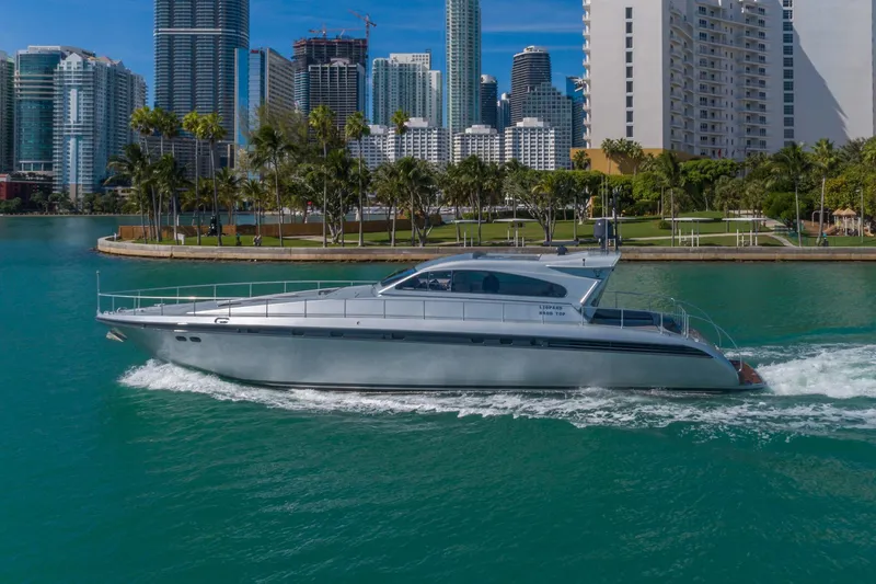 Slide: The Image of 2007 Leopard Express Motor Yacht cruising near city skyline and palm trees. - 2
