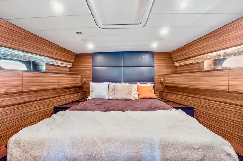 Slide: The Image of Luxurious bedroom interior of 2007 Leopard Express Motor Yacht with wood paneling and cozy bedding. - 20