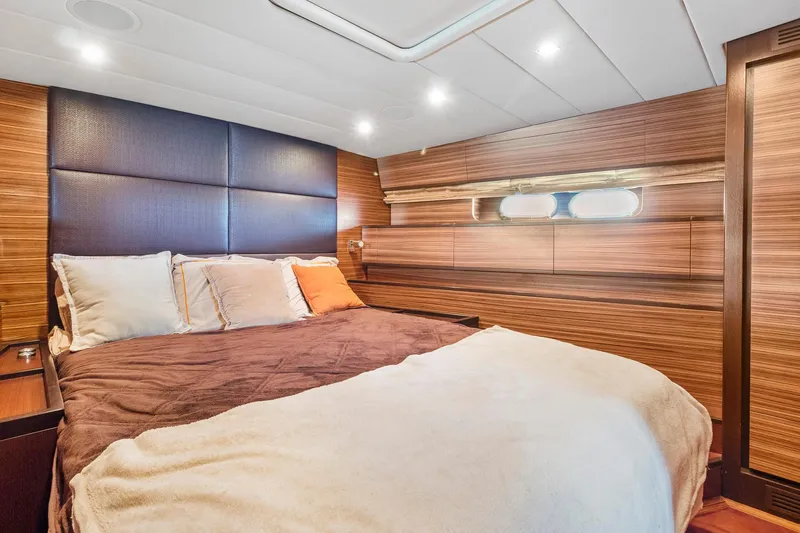 Slide: The Image of Luxurious bedroom interior of 2007 Leopard Express Motor Yacht with wood paneling and cozy bedding. - 21