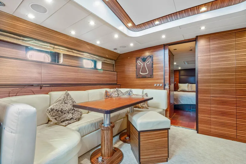 Slide: The Image of Luxurious 2007 Leopard Express Motor Yacht interior with elegant wood paneling and plush seating. - 23