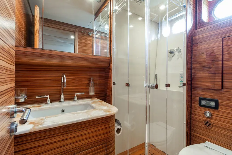 Slide: The Image of Luxurious bathroom in 2007 Leopard Express Motor Yacht with wood paneling and glass shower. - 28