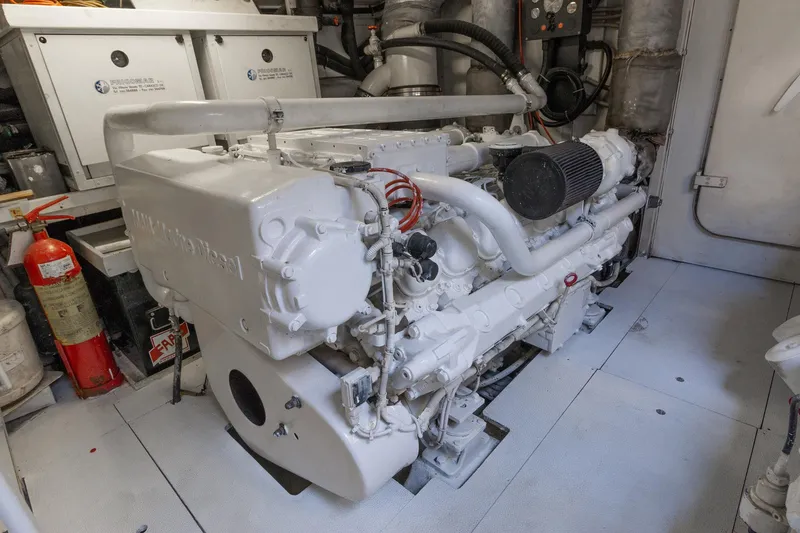 Slide: The Image of Engine room of 2007 Leopard Express Motor Yacht with visible diesel engine and fire extinguisher. - 32