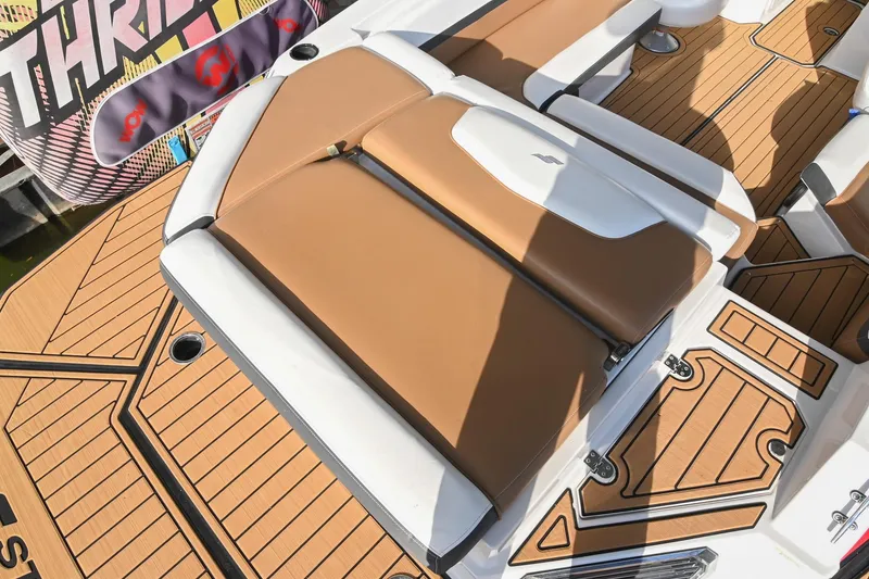 Slide: The Image of 2023 Starcraft SVX 230 IO boat interior with tan and white seating, teak-style flooring. - 11