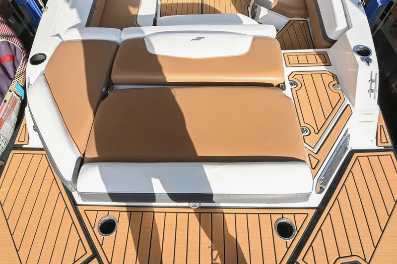 Slide: The Image of 2023 Starcraft SVX 230 IO boat interior with tan and white seating, teak-style flooring. - 12