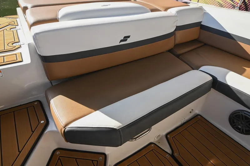 Slide: The Image of 2023 Starcraft SVX 230 IO boat interior with brown and white cushioned seating. - 15