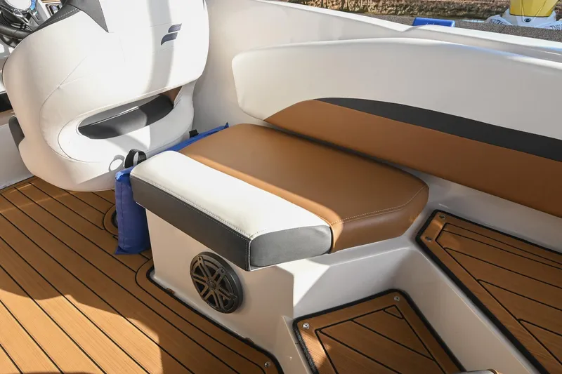 Slide: The Image of 2023 Starcraft SVX 230 IO boat interior with tan and white seating, teak flooring. - 17