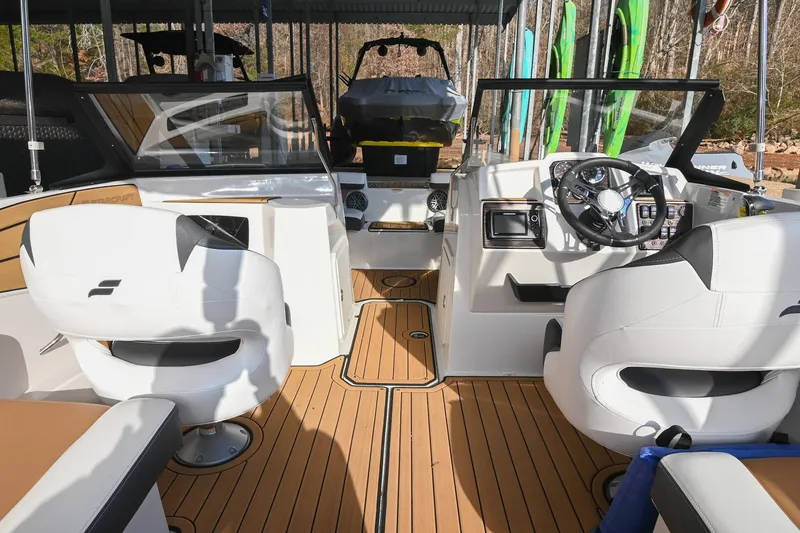 Slide: The Image of 2023 Starcraft SVX 230 IO boat interior with modern dashboard and seating. - 18
