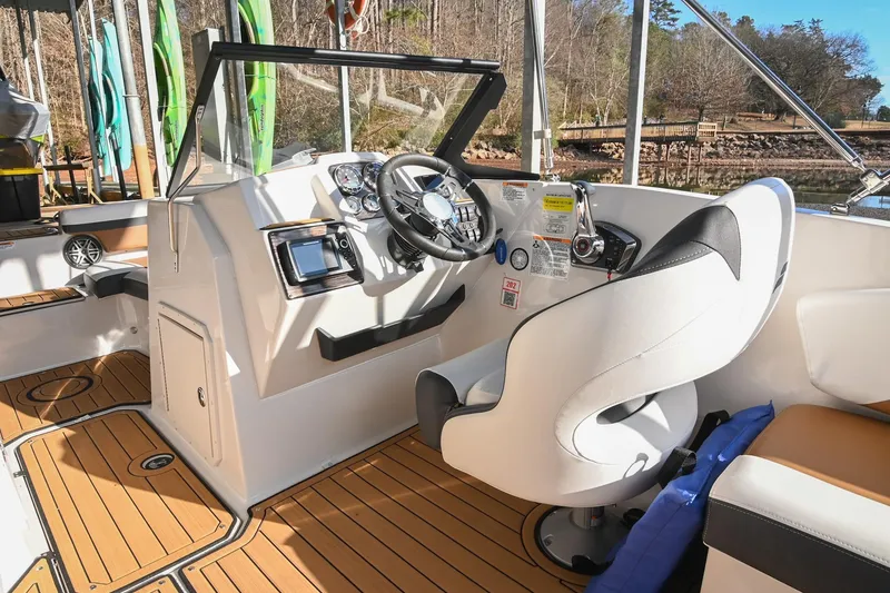 Slide: The Image of 2023 Starcraft SVX 230 IO boat interior with modern helm and seating. - 23