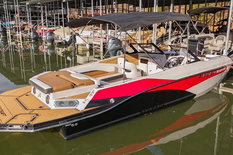 Slide: The Image of 2023 Starcraft SVX 230 IO boat docked, featuring sleek design and modern amenities. - 3