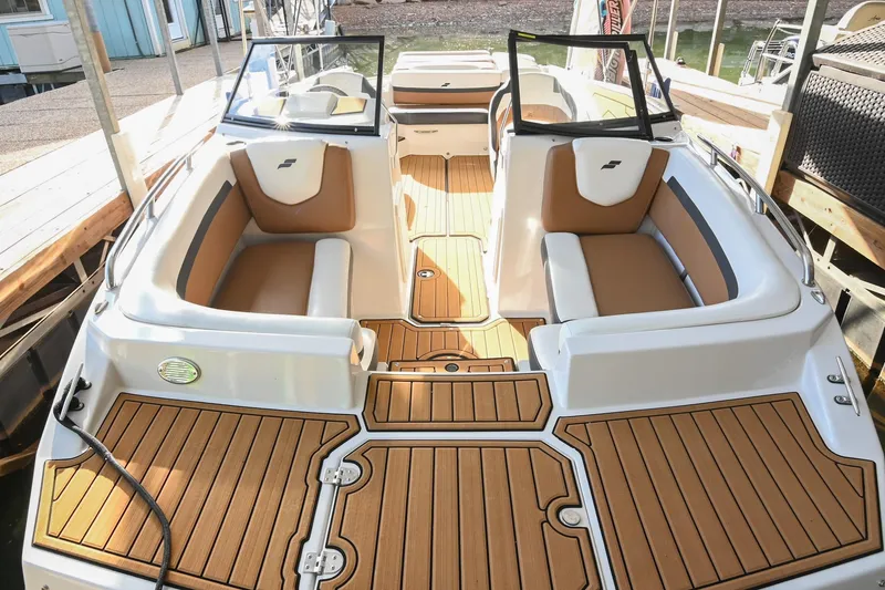 Slide: The Image of 2023 Starcraft SVX 230 IO boat interior with tan seating and wood-style flooring. - 40