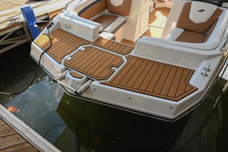 Slide: The Image of 2023 Starcraft SVX 230 IO boat with teak-style swim platform at dock. - 41